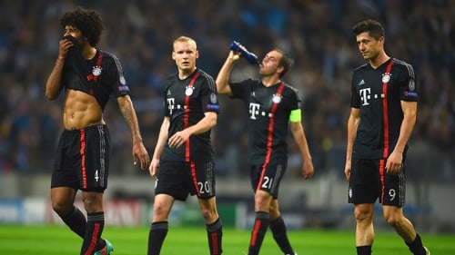 Sebastian Rode, Philipp Lahm and Robert Lewandowski of Bayern Muenchen look dejected in defeat