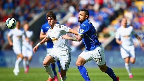 Nelson Oliveria of Swansea City (l) and Marcin Wasilewski of Leicester City