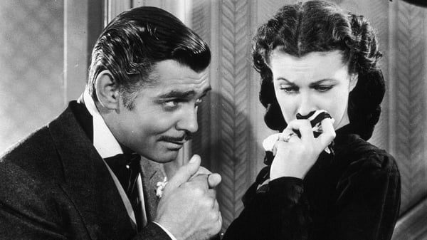 Rhett Butler (Gable) kisses the hand of a tearful Scarlett O'Hara in Gone with the Wind