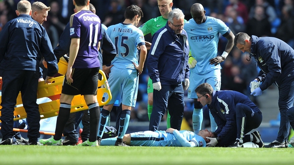 David Silva receives medical attention before being stretchered off to hospital