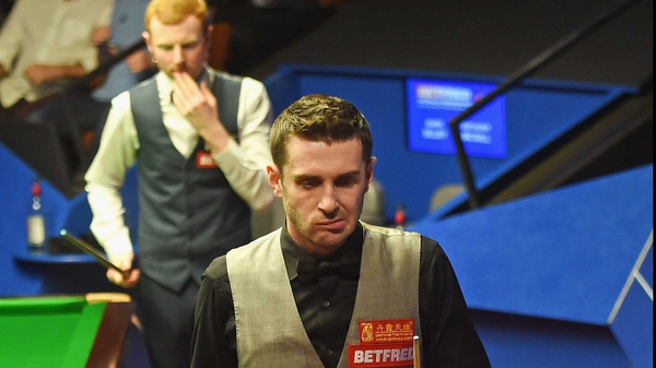 Mark Selby (r) suffered a shock 13-9 loss to Anthony McGill
