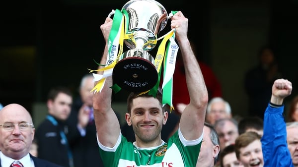 Paul McConway lifts the Division 4 trophy