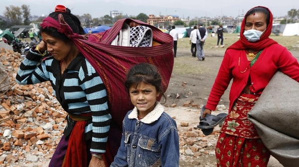 Families return home from tents in the aftermath of the earthquake