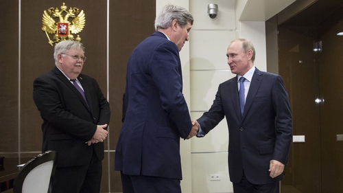 John Kerry and Vladimir Putin shake hands ahead of their meeting in Sochi
