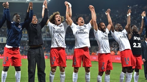 Paris St Germain's players celebrate in front of their travelling fans at the Stade de la Mosson