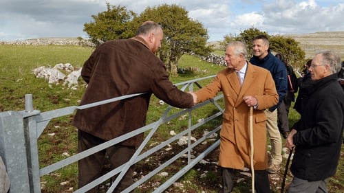 Prince Charles shakes hands with local farmer Oliver Nagle with his father Pat (R) looking on during his visit to the Burren, Co Clare