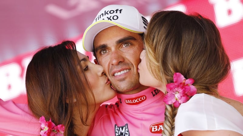 Alberto Contador gazes into the distance as he is congratulated on extending his lead in the GC