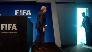 Sepp Blatter walks to the door after announcing his departure