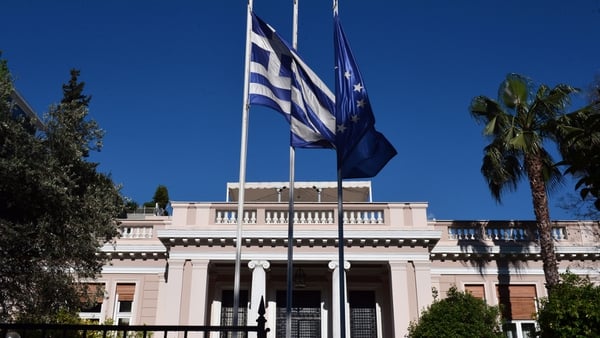Greek and EU flags outside the Prime Minister's office in Athens