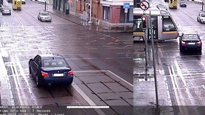 Image shows a car in a near miss with a Luas after going through a red light