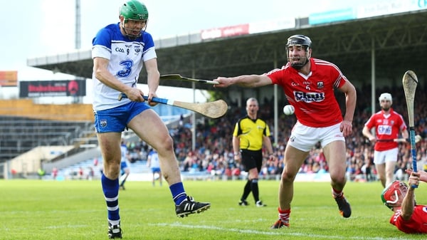 Waterford's Tom Devine scores a goal in the league final despite the efforts of Cork's Mark Ellis