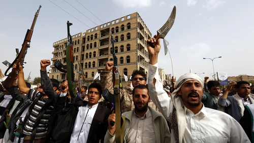 Supporters of the Houthis in Yemen carry guns during a rally protesting Saudi-led military operations