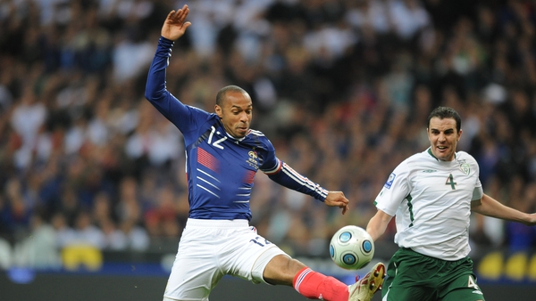 Thierry Henry (Left) controls the ball with his foot - in front of John O'Shea during the World Cup play-off in 2009