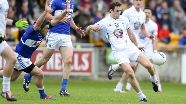 Laois' Brendan Quigley attempts to block Kildare's Cathal McNally