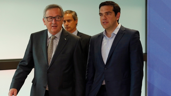 EU Commission President Jean-Claude Juncker (L) welcomes Alexis Tsipras (R) prior to a meeting at the EU commission HQ in Brussels