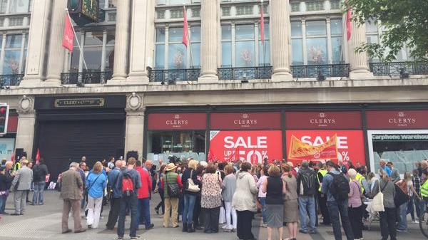 Workers and supporters gather under Clerys clock for a protest over its sudden closure