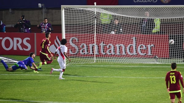 Claudio Pizarro scores past Venezuela's goalkeeper Alain Baroja