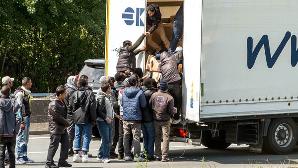 Crowds of migrants were seen trying to board waiting lorries