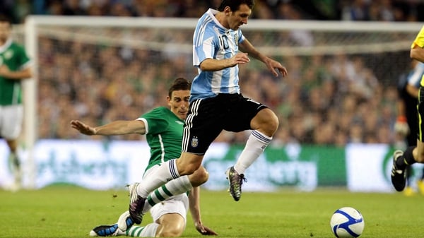 Keith Andrews tries to tackle Lionel Messi during the 2010 friendly