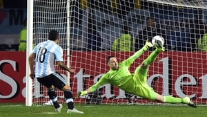 Carlos Tevez scores the winning penalty past Colombia's goalkeeper David Ospina