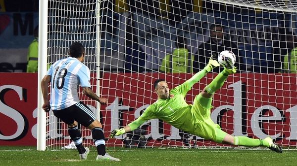 Carlos Tevez scores the winning penalty past Colombia's goalkeeper David Ospina