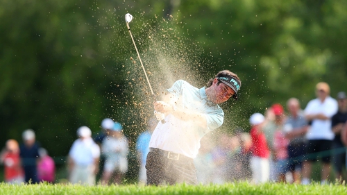 Bubba Watson plays a shot from a bunker on the 13th hole