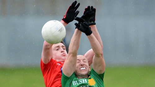 Louth's Tommy Durnin goes for the ball in competition James McGrail of Leitrim