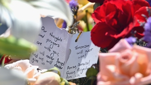 A note reads 'terrorism will not win', people leave flowers and cards at the site of the attack