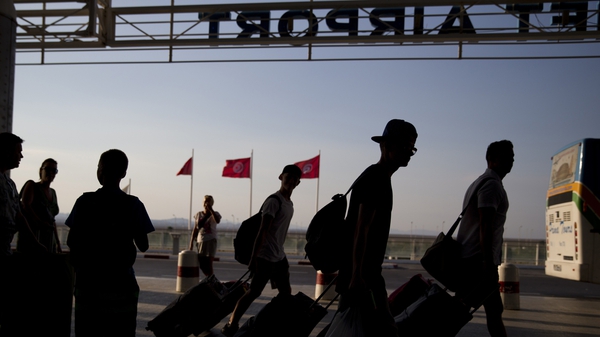 Tourists arrive at the Enfidha International airport to leave Tunisia