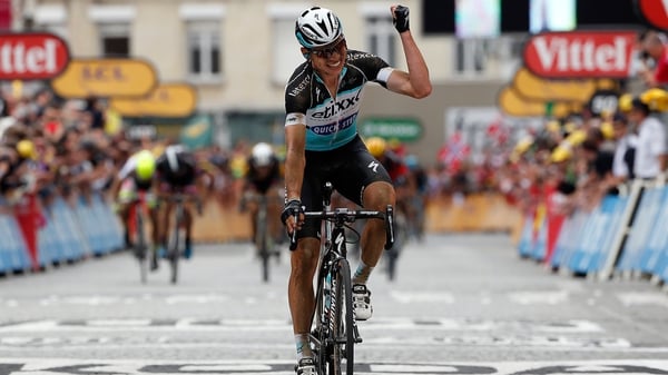 Tony Martin celebrates as he crosses the line to claim both the fourth stage and the leader's yellow jersey