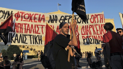 Anti-austerity protesters demonstrate in front of the Greek Parliament in Athens