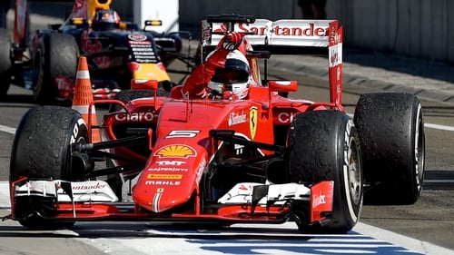 Sebastian Vettel celebrates winning in his Ferrari