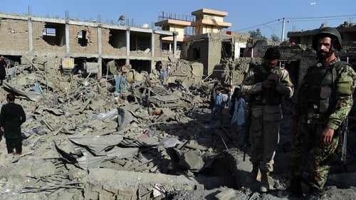 Afghan security force and residents inspect damage houses near of a powerful truck bomb in Kabul