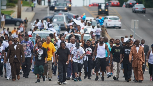 Marchers shouted slogans such as 'Hands up, don't shoot' and 'We do this for who? We do this for Mike Brown.'