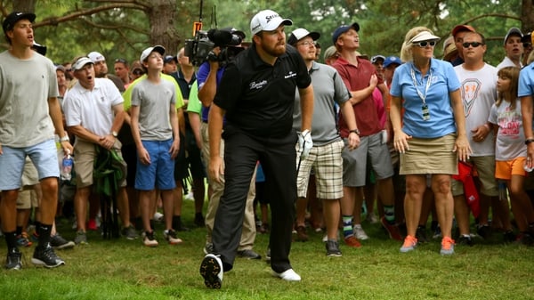 Shane Lowry looks on after hitting a vital recovery shot on the 18th hole