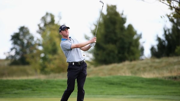 Michael Hoey watches his iron shot on the second hole at Albatross Golf Resort