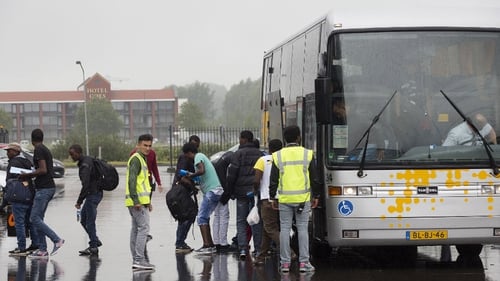 Asylum seekers arrive by bus at the Zeelandhallen in Goes in southwestern Netherlands