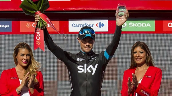 Nicolas Roche celebrates on the podium after winning the 18th stage