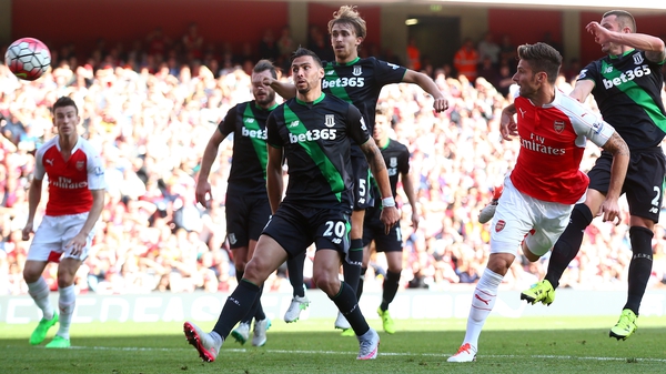 Olivier Giroud (right) heads home Arsenal's second late on