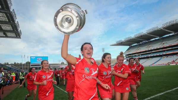 Cork's Ashling Thompson celebrates with the O'Duffy Cup after the game