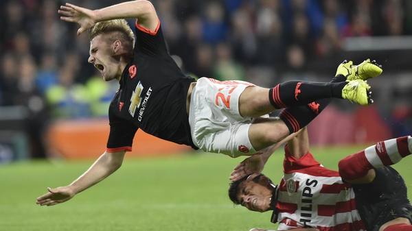 Luke Shaw (L) is challenged by Eindhoven's Hector Moreno