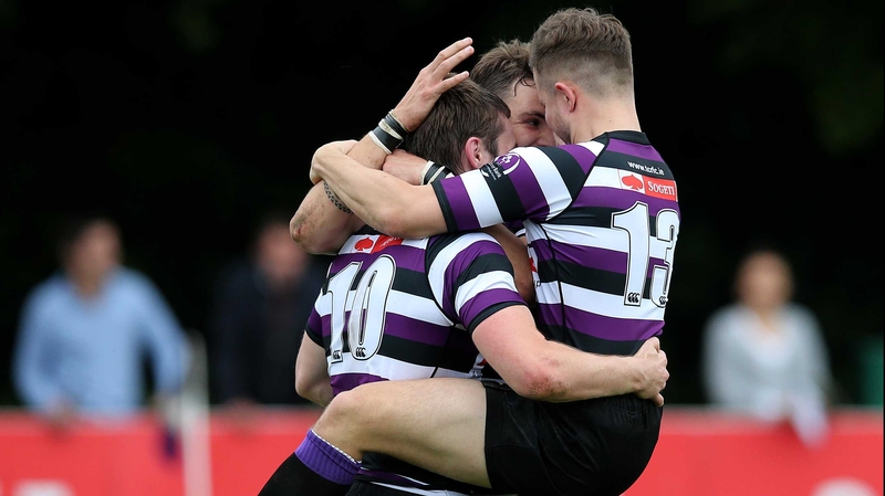 Terenure's James O'Donoghue celebrates his try with Stephen O'Neill and Harrison Brewer