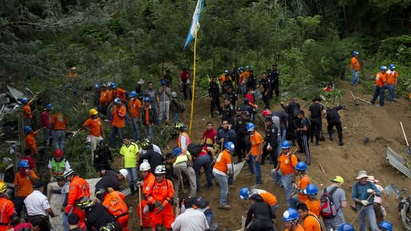 Rescue workers search for survivors of the landslide