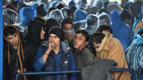 Migrants queue at a border crossing between slovenia and Croatia