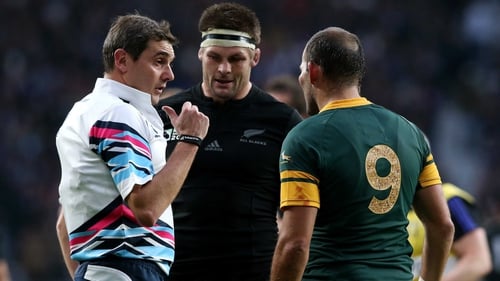 Referee Jerome Garces talks to captains Richie McCaw of New Zealand All Blacks and South Africa's Fourie Du Preez