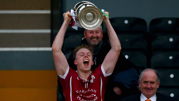 Clara captain Keith Hogan lifts the cup