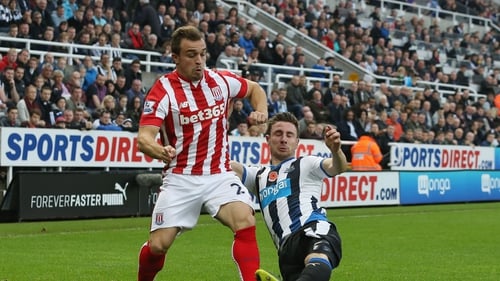 Xherdan Shaqiri of Stoke City is tackled by Newcastle's Paul Dummett