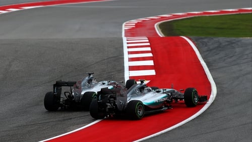 The Mercedes of Lewis Hamilton and Nico Rosberg touch wheels at the first turn in Austin