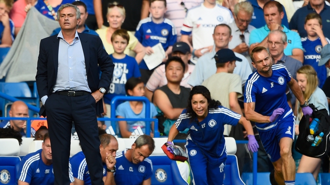 Chelsea manager Jose Mourinho looks on as Eva Carneiro rushes to treat Eden Hazard