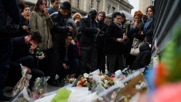 Crowds gather outside Le Petit Cambodge in Paris